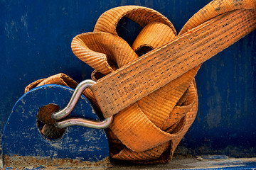orange tension belt on blue machine on a construction site
