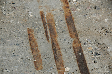 Disused rail remains seen in the pavement of a pier. There seemed to be a switch here.