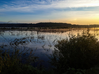 Colorful landscape with evening sunset on the lake.