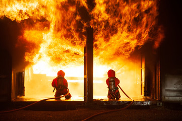 Firefighters spraying water to put out a brutal fire inside the building.