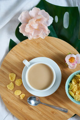 White cup of coffee latte on exotic background. Breakfast concept Top view Copy space