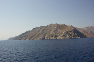 Greece. Rhodes island. Rest at the sea. Euro-trip. Sea water surface. Mountains in the background.