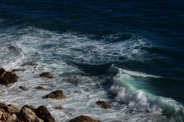 Ocean wave background breaking sea water rocky shore