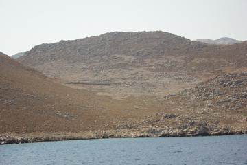 Greece. Rhodes island. Rest at the sea. Euro-trip. Sea water surface. Mountains in the background.
