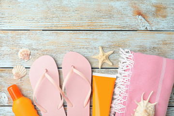 Beach objects on wooden background, flat lay
