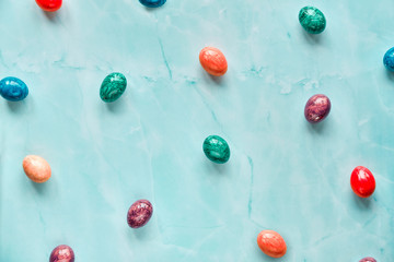 Geometric sweet minimal Easter background with marble painted Easter eggs on light stone table