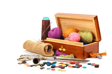 Thread, buttons, scissors on white background. Sewing supplies. 