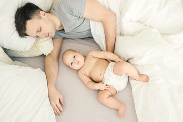 Obraz na płótnie Canvas Father sleep near cute baby.