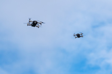 Two small drones flying in the sky 