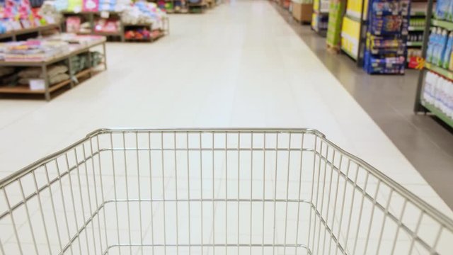 supermarket shopping time lapse shopping trolley. the cart is driving through the supermarket