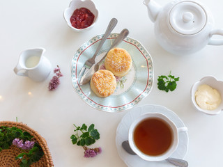 Breakfast tea set with fresh buns, butter, jam. Good morning.
