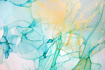 Alcohol ink blue and green abstract background with golden glitter. Ocean style watercolor texture.