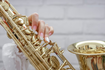 Female saxophone player with nails done