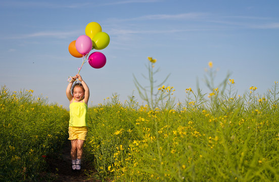 Girl Letting Go Balloons Flying In The Sky. Happy Child Waving Hand.