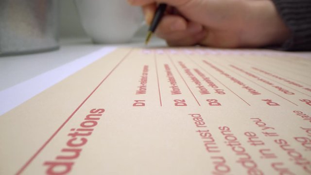 Motorized moving shot of completing deduction section in Australian tax form, shot with macro probe lens