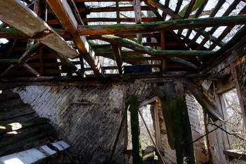 Fototapeta na wymiar The ruins of an old abandoned house. Inside view. A dilapidated rural house.