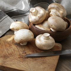 Champignon mushrooms in wood bowl