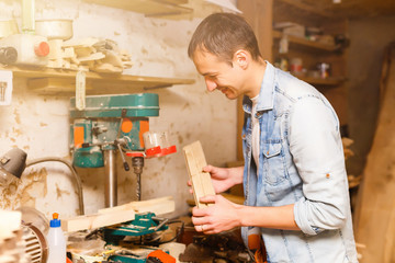 Carpenter works in a workshop for the production of vintage furniture