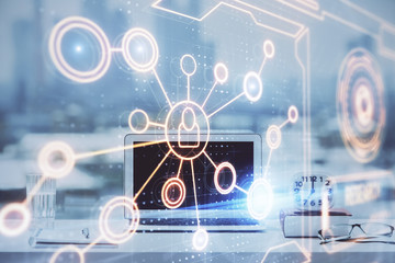 Computer on desktop with social network hologram. Double exposure. Concept of international people connections.