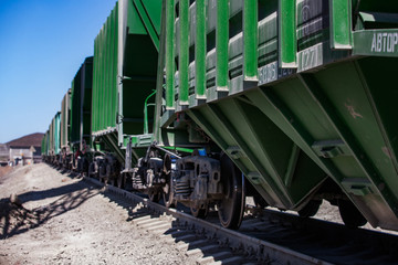 Mynaral/Kazakhstan: Modern cement plant in desert. Hopper car on railroad terminal. Railway carriages on track. Close-up.