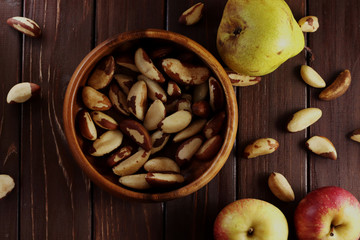 nuts on a wooden table, apples and 
pear