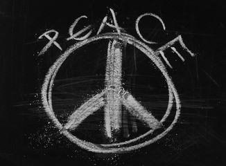 Peace symbol, sign on black chalkboard, blackboard background and texture