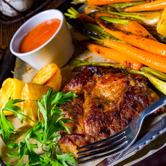 grilled neck chops with caramelized vegetables.