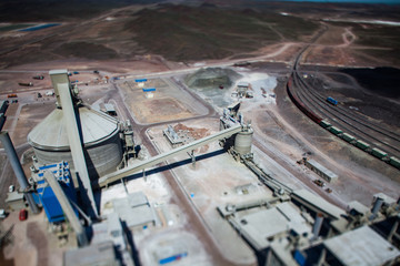 Mynaral/Kazakhstan: Jambyl Cement plant. Aerial view on concrete silo and conveyor and railroad. Tilt-shifted blurred photo.