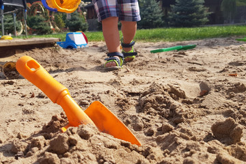 children's sandbox and colored plastic toys for children to play in the open air on a summer day.