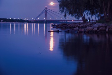 Fototapeta na wymiar Bridge at night, night lights, moonlight, moon reflections, landscape 