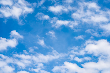 Naklejka na ściany i meble Beautiful blue sky with fluffy clouds as a background