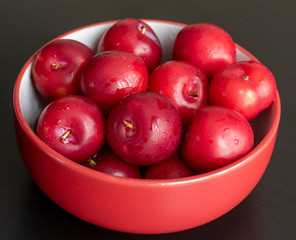 Red plum in a bowl