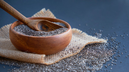 Chia seeds on wooden spoon isolated on white background. Chia grains that can be eaten to reduce weight well and high in protein and phosphorus,high in fiber and low calories. clean food and superfood