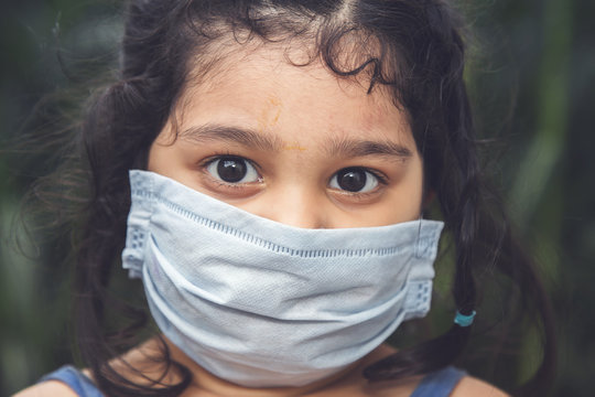Little Indian girl wearing mask for stop corona virus outbreak.