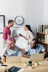 Fototapeta premium Selective focus of business people working with gadgets in office