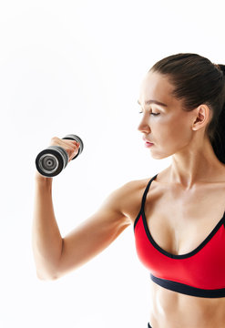 Sporty woman in sportswear doing exercise with dumbbells on white background.