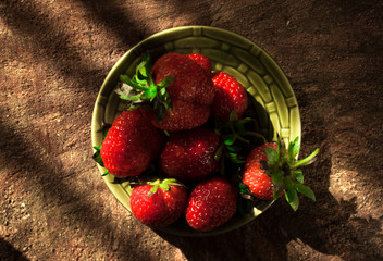 strawberries on a plate, harsh light