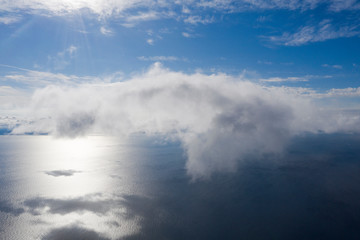 Naklejka na ściany i meble Aerial view small clouds over the sea. View from drone. Aerial top view cloudscape. Texture of clouds. View from above. Sunrise or sunset over clouds. Aerial ocean background