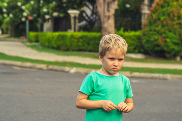 Portrait handsome cute serious sad blond boy in bad mood look away. Artistic emotions. Problem or happy childhood, behaviour education psychology, family relationship concept