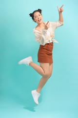 Asian young woman jumping and expressing happiness.