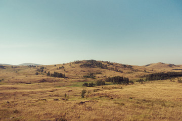 Fototapeta na wymiar Russia. Travel across Russia. Hills, mountains and fields. Panorama of the steppes.