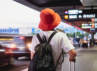 Solo traveler carry luggage walking in airport