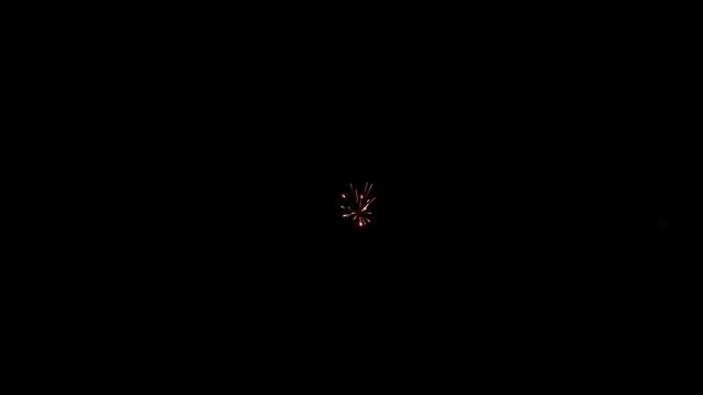 Element of multicolored firework on black background to create a set of salutes through mounting. Slow Motion shot.