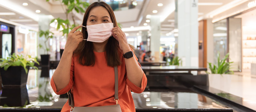 Young Asian Woman With Face Mask In The Shopping Mall.