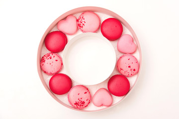 Traditional french colorful macarons. Valentine's day gift. Pink macarons in the heart shape.