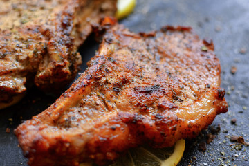 Grilled juicy meat. Turkey steak. Close-up. marinated meat with lemon and herbs. Free space for text.