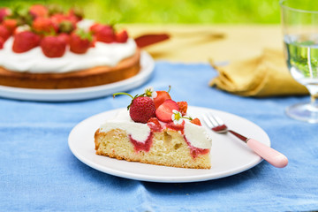 Pie with cream and strawberries on a summer background. . Homemade summer dessert.