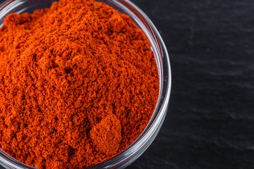 aromatic ground paprika on a dark stone background