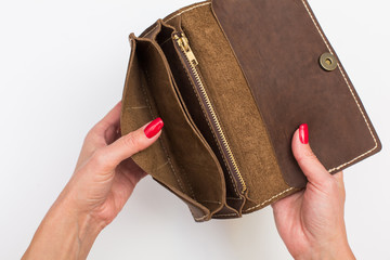 Hands open an brown empty wallet, no money, lack of financial liquidity, Economic downturn