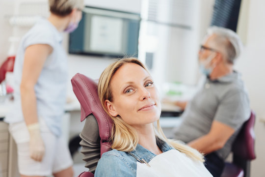 Smiling woman in the chair at the dentist